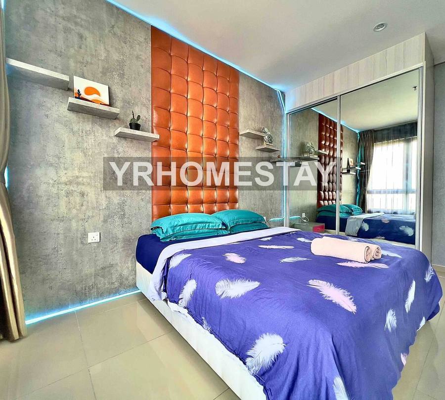 Bedroom with a queen bed, mirrored wardrobe and a brick feature wall behind the headboard.