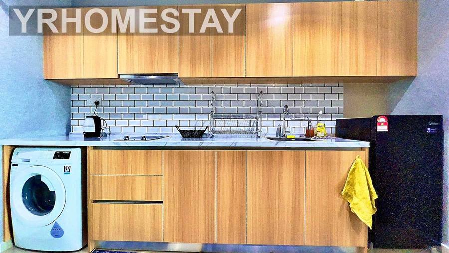 Kitchen with wooden cabinetry, a hob, sink, fridge and a washing machine built in below the counter.