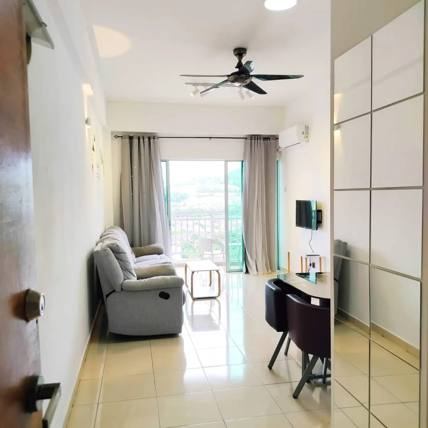 The balcony at Comfy Home, looking out over Bayan Lepas towards the hills